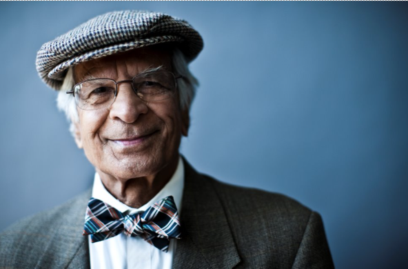 An older man in a golf hat