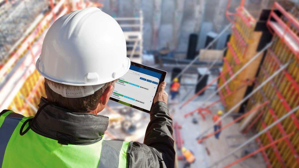 building inspector on construction site with tablet